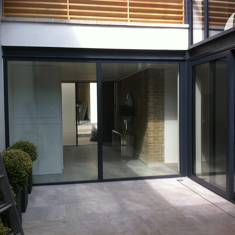 Floor-to-ceiling sliding doors opening to courtyard in Cricklewood