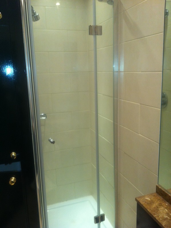 Frameless glass shower enclosure with chrome fittings in Cricklewood