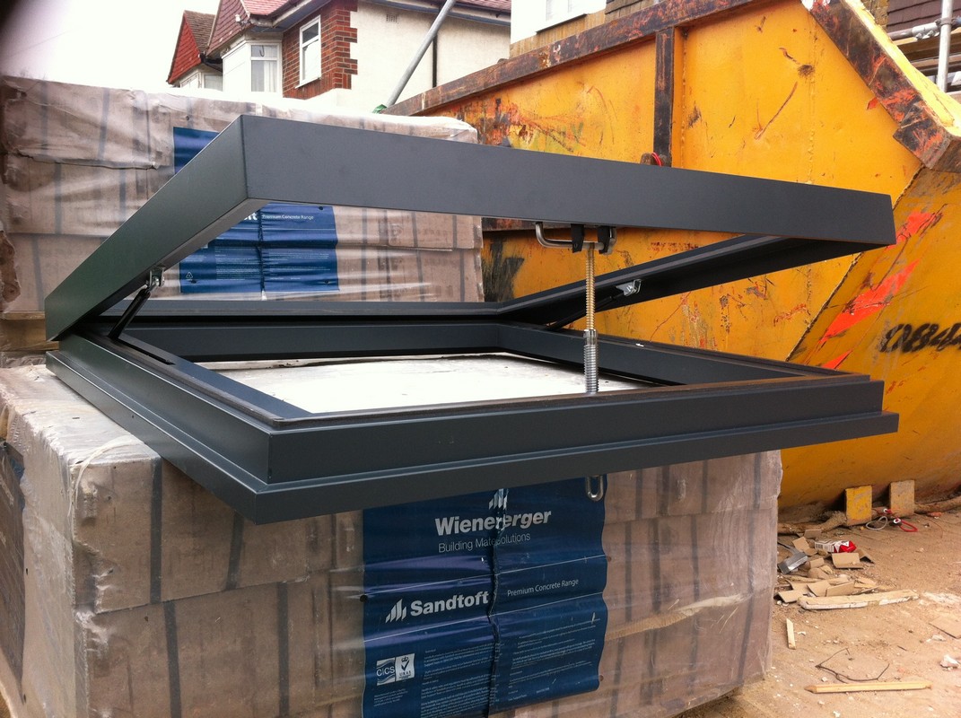 Opening flat roof skylight in anthracite grey installed in Cricklewood