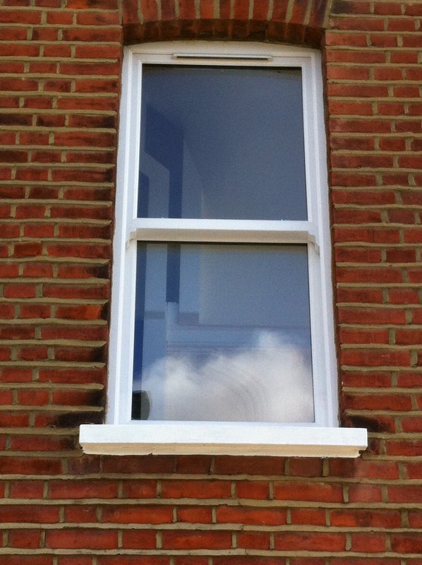 uPVC sash window on Victorian red brick house in Cricklewood